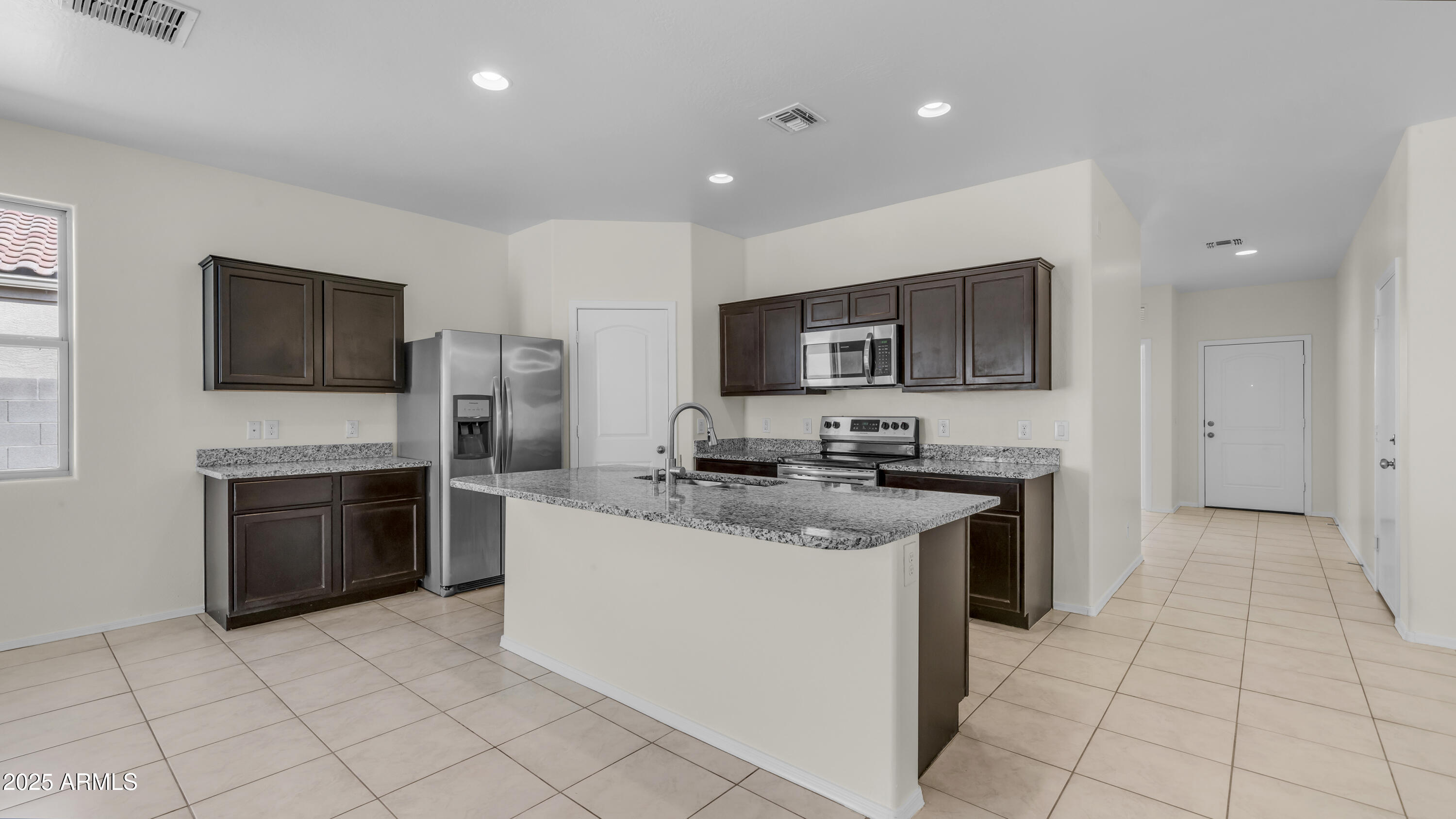 42017 West Rosa Drive Maricopa, AZ 85138 - Photo 2 of 13 a kitchen with stainless steel appliances granite countertop a sink dishwasher stove and a refrigerator