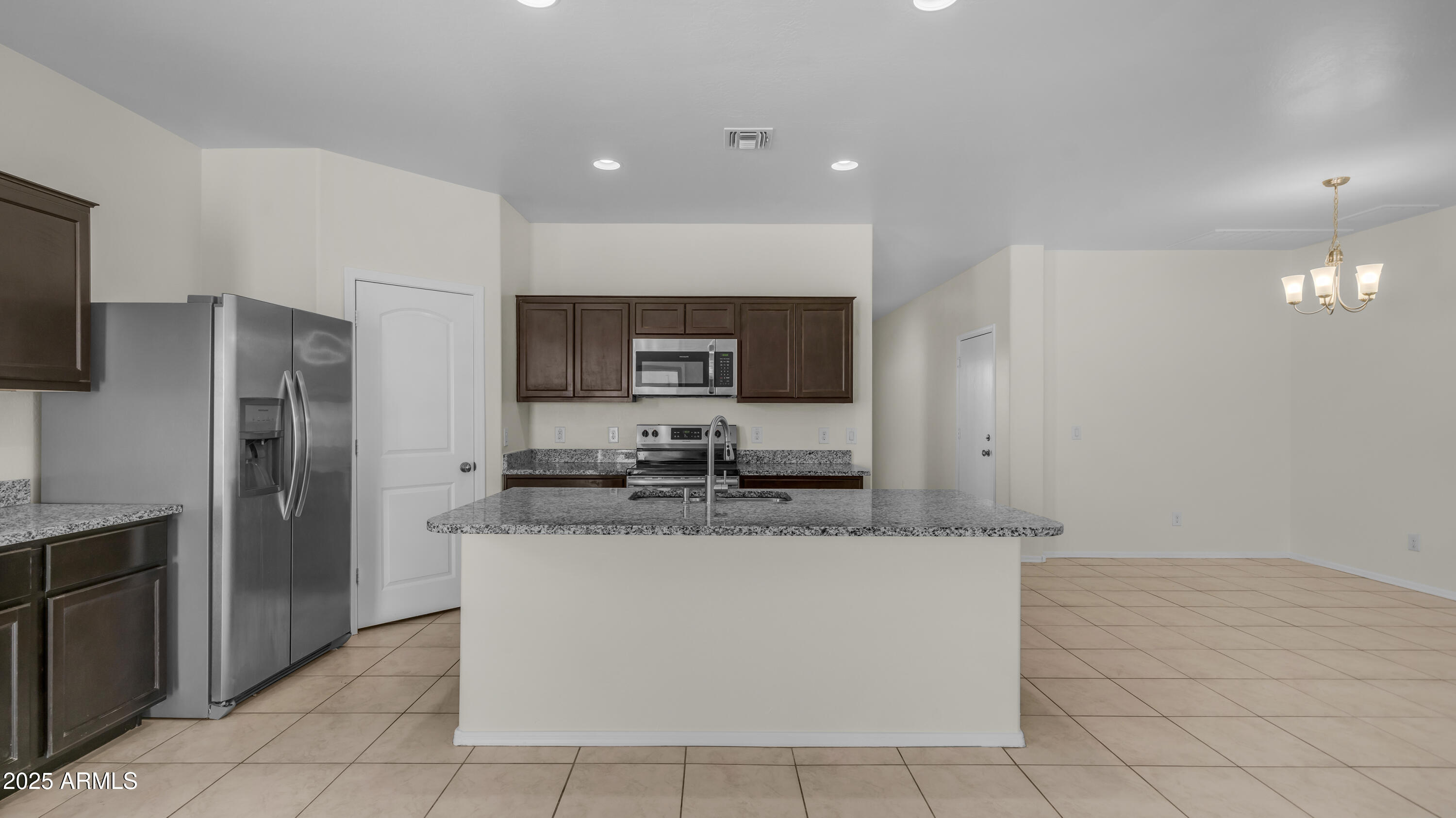 42017 West Rosa Drive Maricopa, AZ 85138 - Photo 3 of 13 a large kitchen with kitchen island a counter top stainless steel appliances and cabinets