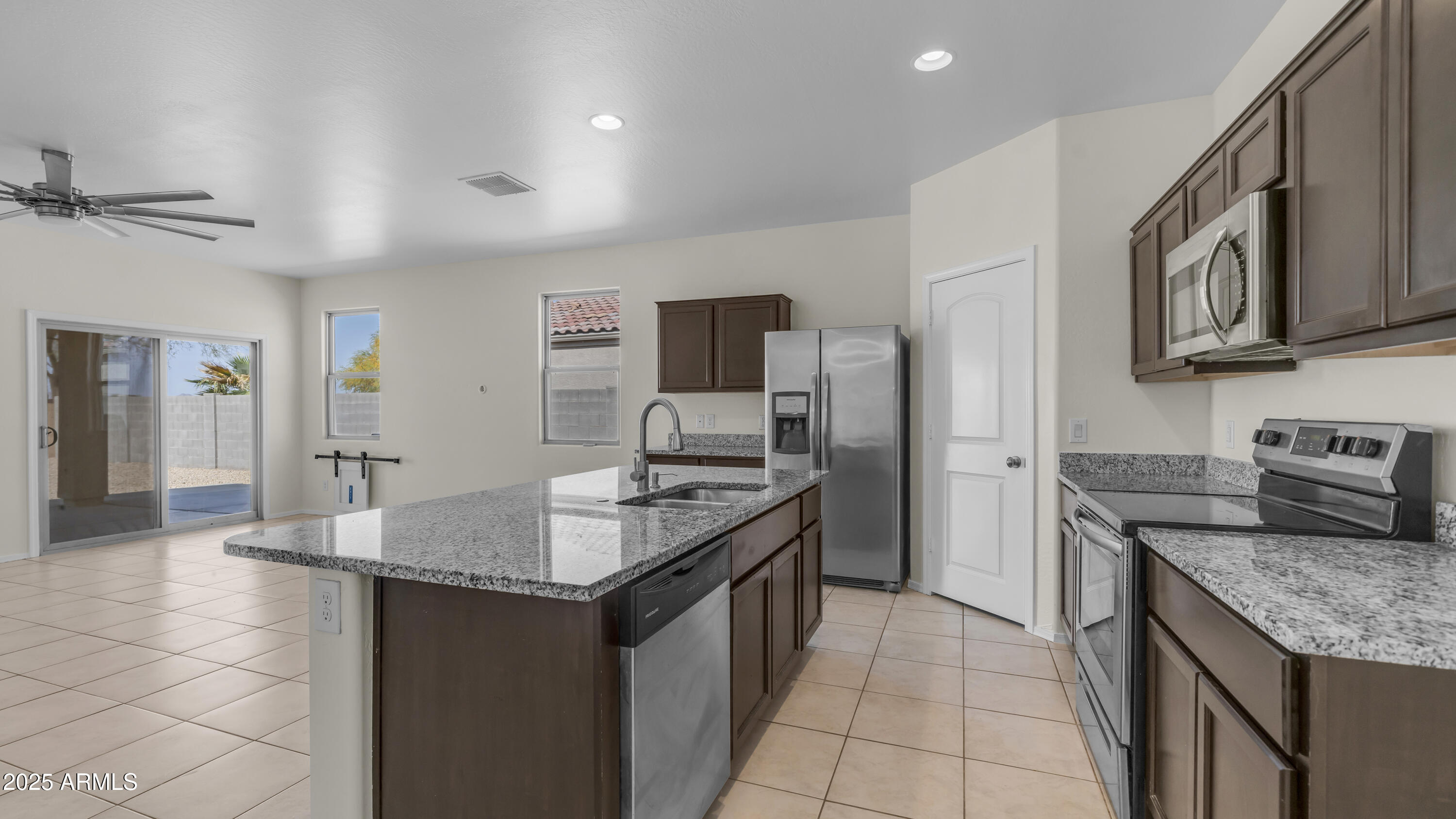 42017 West Rosa Drive Maricopa, AZ 85138 - Photo 4 of 13 a kitchen with granite countertop a sink and a stove