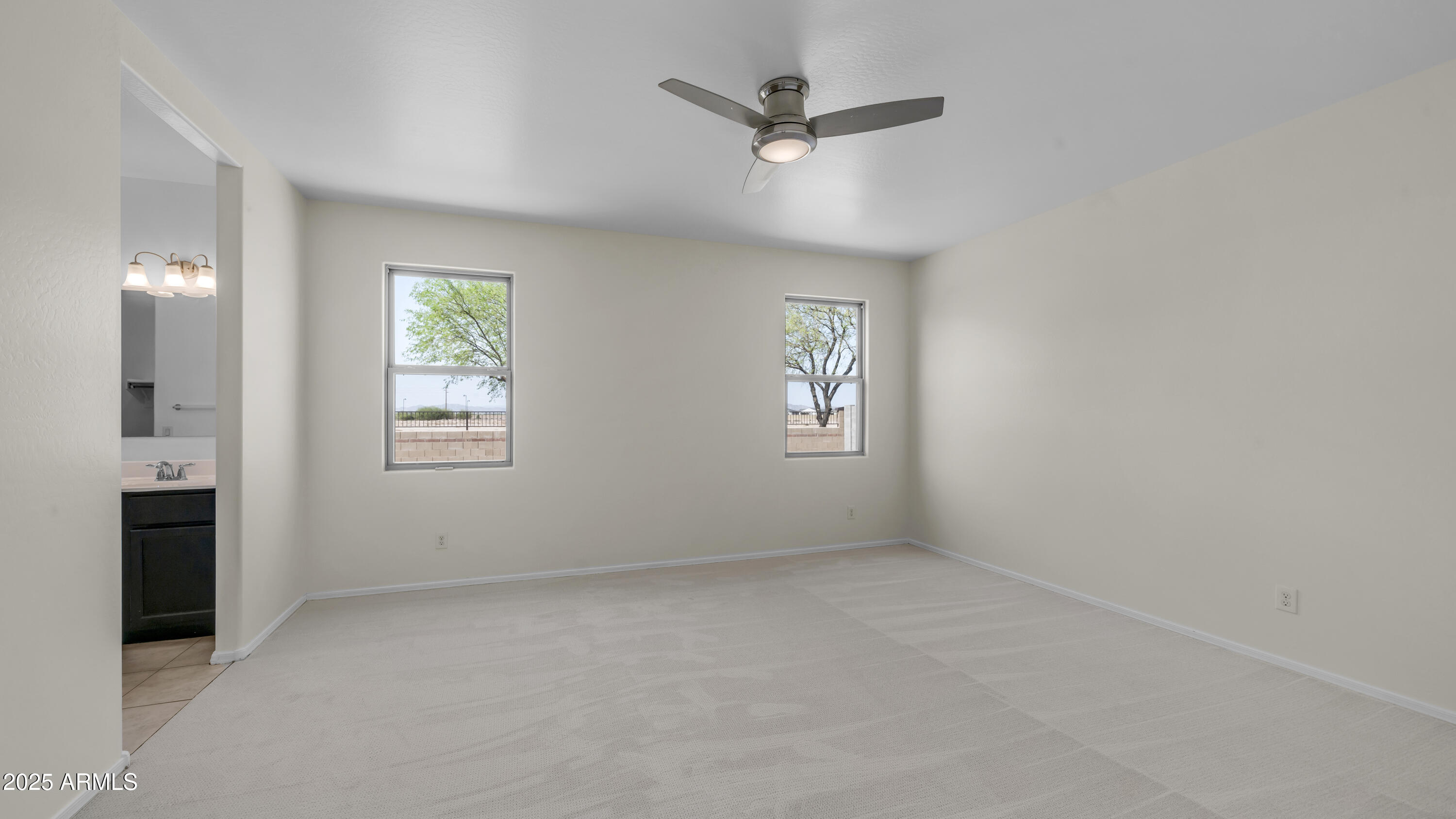 42017 West Rosa Drive Maricopa, AZ 85138 - Photo 6 of 13 an empty room with windows and fan
