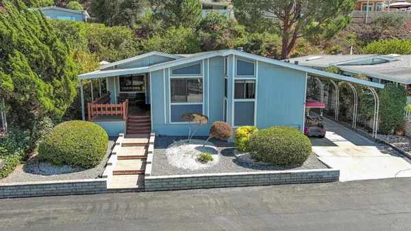 a backyard of a house with yard and outdoor seating
