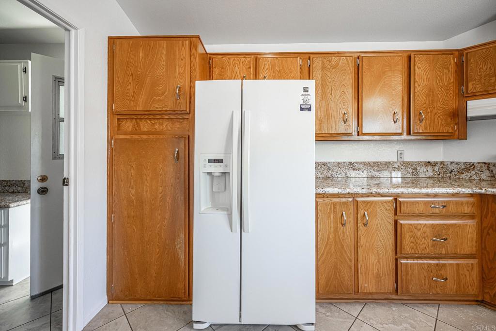 4650 Dulin Road, Unit 178 Fallbrook, CA 92003 - Photo 16 of 56 a white refrigerator freezer sitting in a kitchen