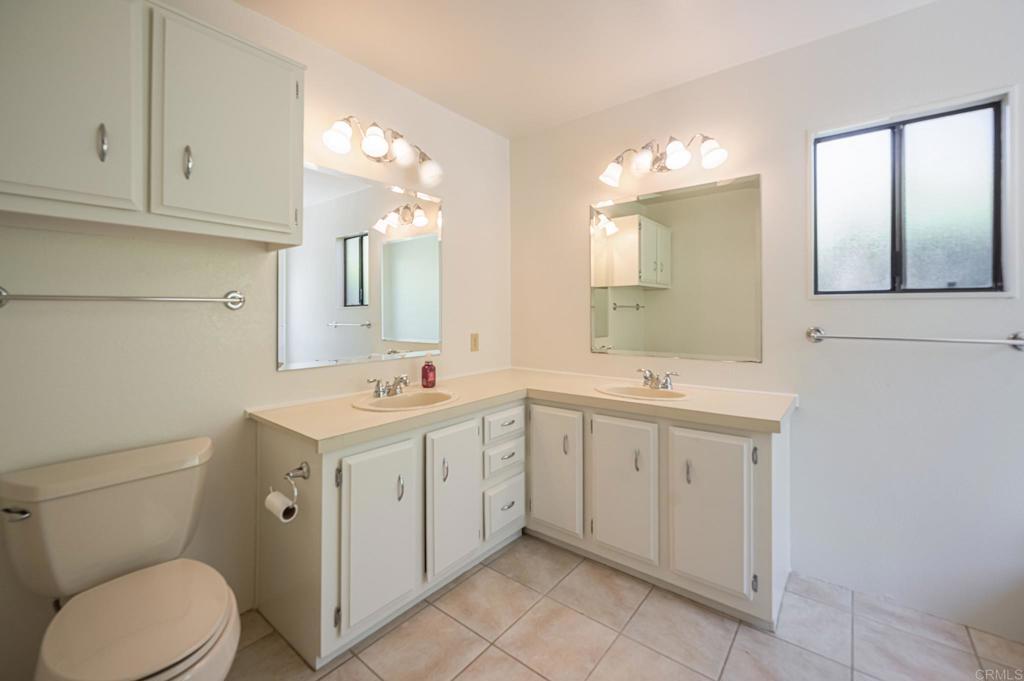4650 Dulin Road, Unit 178 Fallbrook, CA 92003 - Photo 27 of 56 a spacious bathroom with a toilet sink and mirror