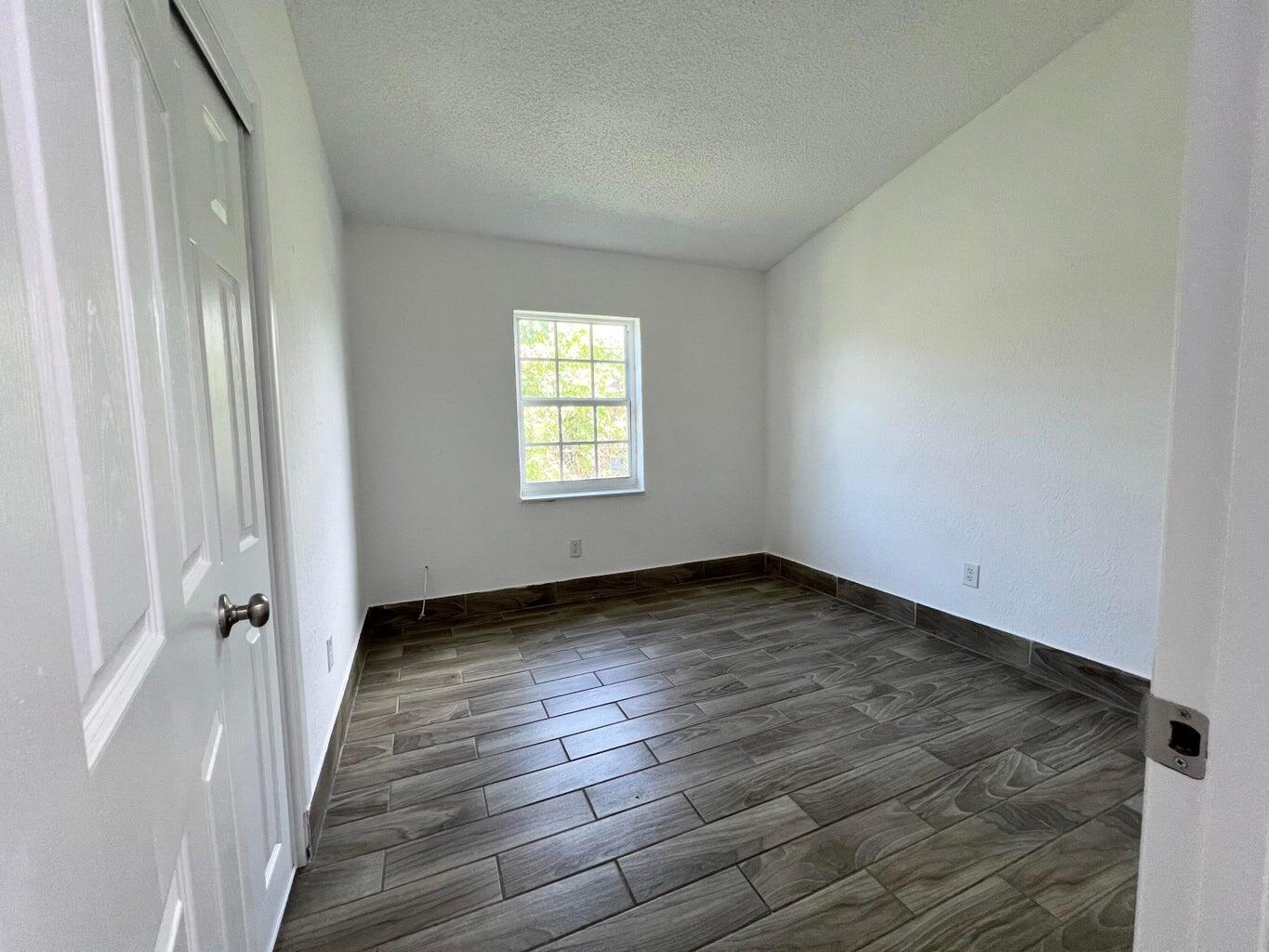 1050 West 7th Street Riviera Beach, FL 33404 - Photo 6 of 15 a view of a room with wooden floor and window