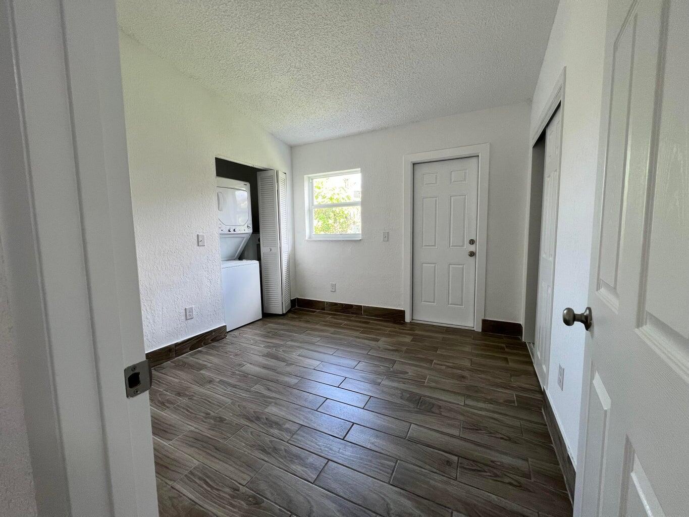 1050 West 7th Street Riviera Beach, FL 33404 - Photo 7 of 15 a view of a livingroom with wooden floor and window