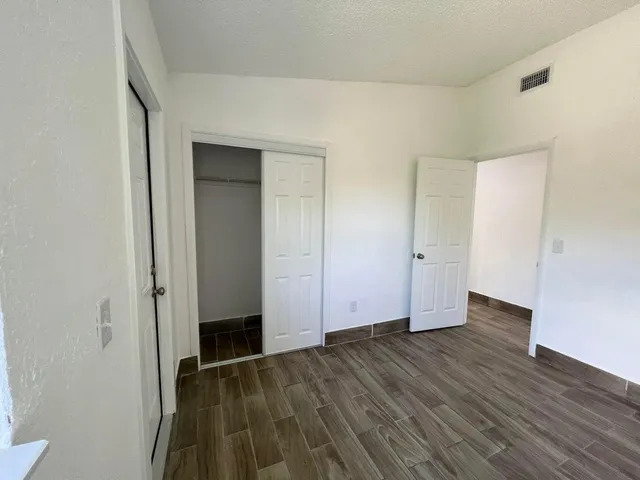 an empty room with wooden floor