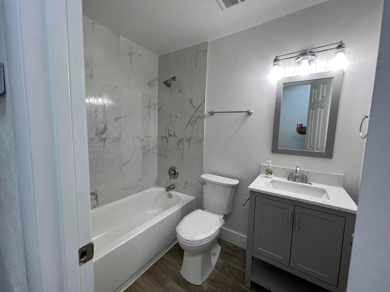 1050 West 7th Street Riviera Beach, FL 33404 - Photo 10 of 15 a bathroom with a toilet sink and mirror