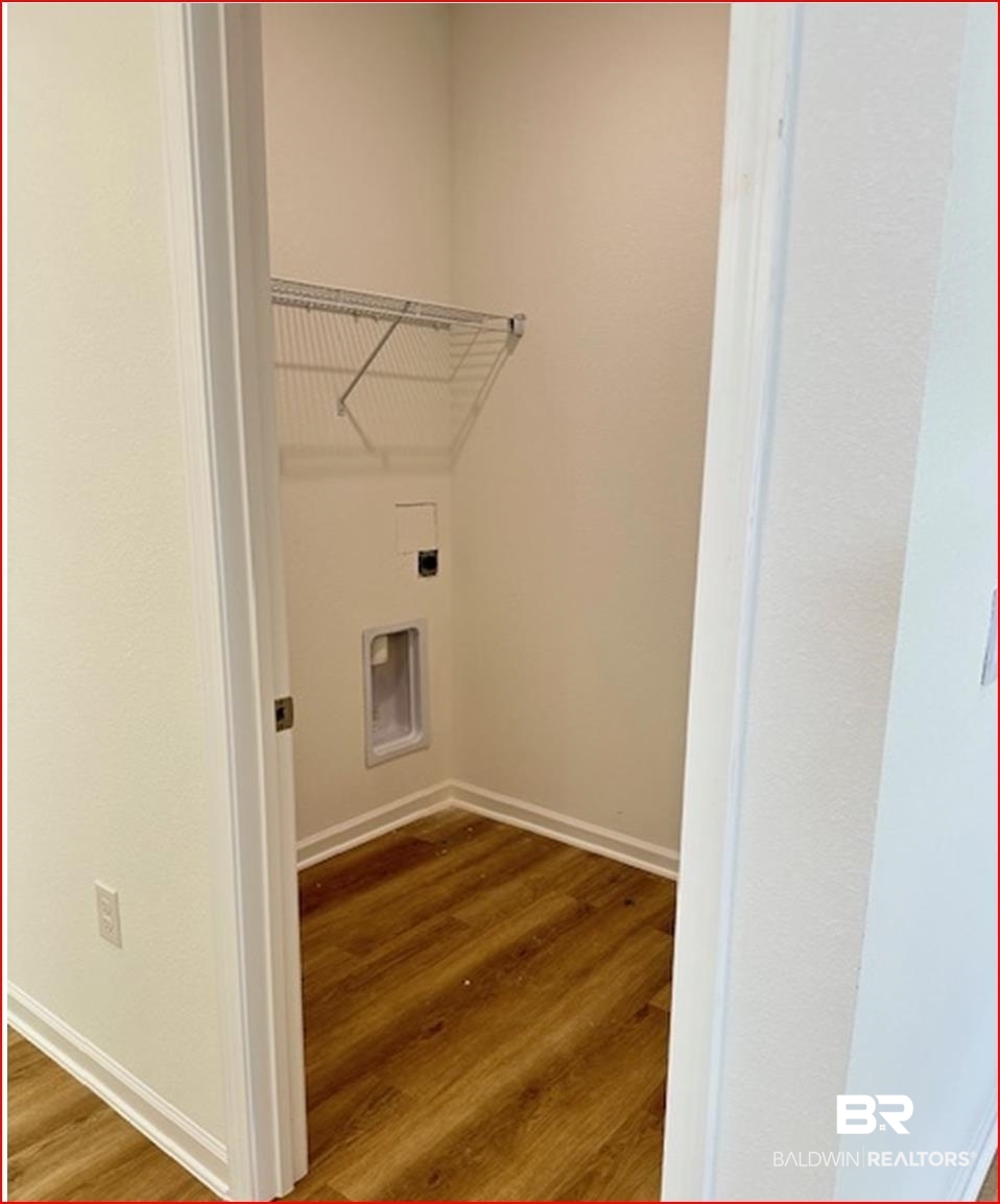 13906 Antler Hl Road Daphne, AL 36527 - Photo 8 of 23 Laundry area with electric dryer hookup and dark wood-type flooring