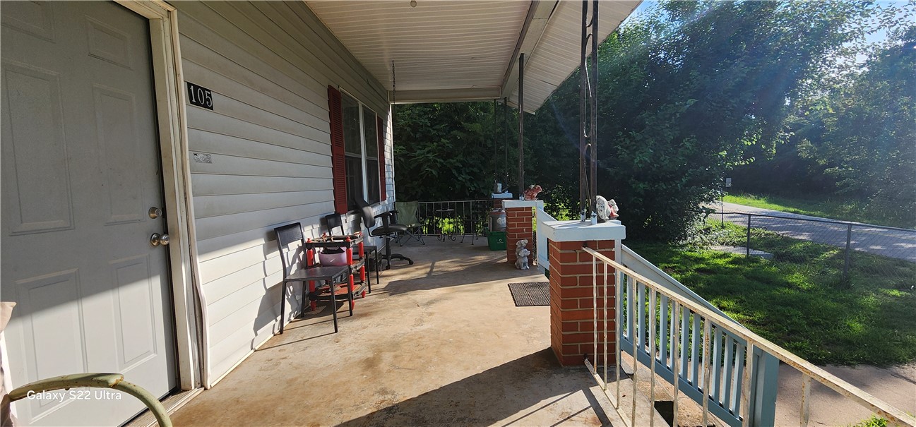 105 Hope Avenue Seneca, SC 29678 - Photo 5 of 33 A welcoming front porch, adorned with brick accents, extends an inviting space for relaxation.