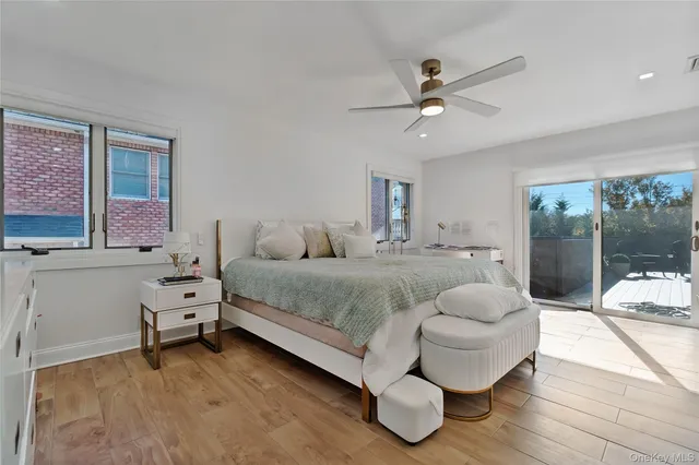 a spacious bedroom with a bed and large window