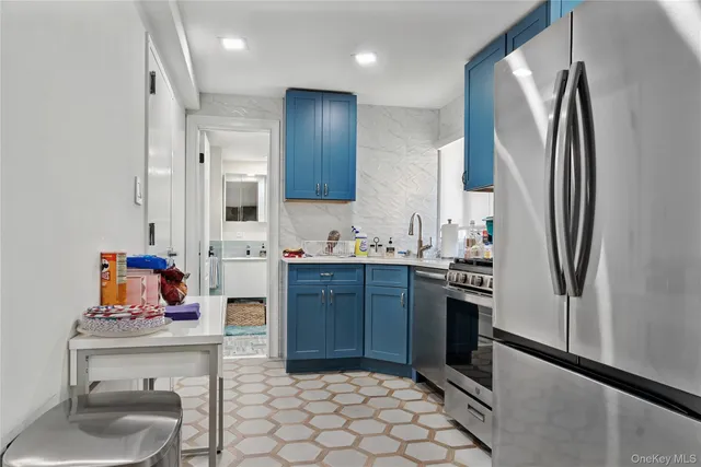 a kitchen with stainless steel appliances granite countertop a refrigerator and a sink