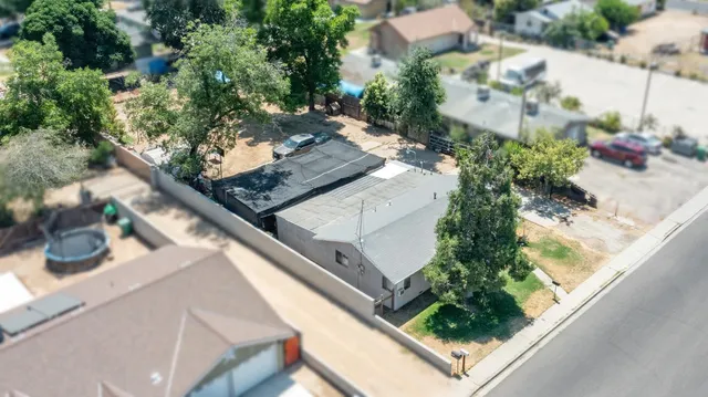 an aerial view of a house with a yard and garden