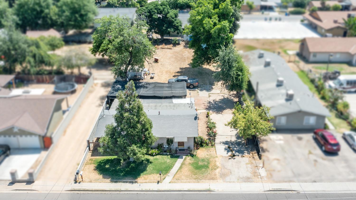 216 South Sunset Avenue Reedley, CA 93654 - Photo 3 of 6 an aerial view of a house with a yard and garden