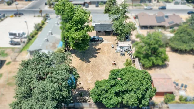 an aerial view of a house with a yard and garden