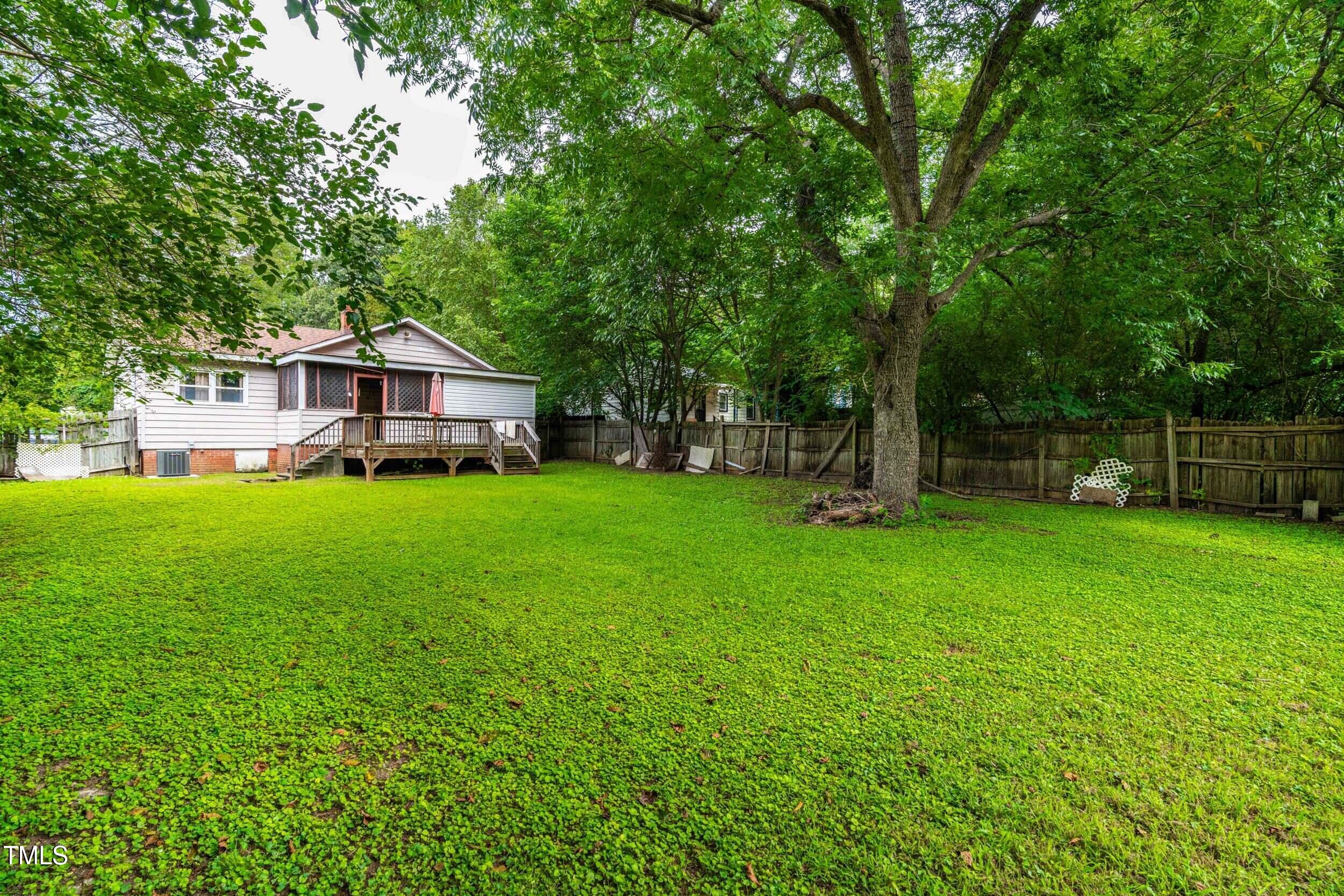 1317 Curfman Street Raleigh, NC 27603 - Photo 12 of 29 a view of a house with a big yard and large trees