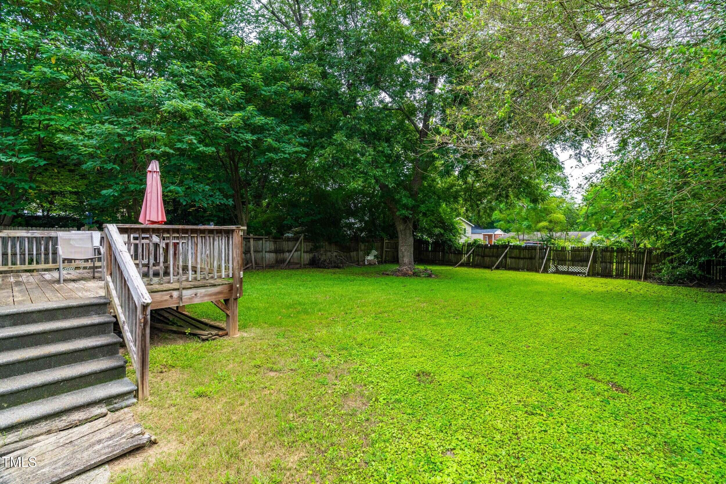 1317 Curfman Street Raleigh, NC 27603 - Photo 17 of 29 a view of a deck and backyard with a small cabin