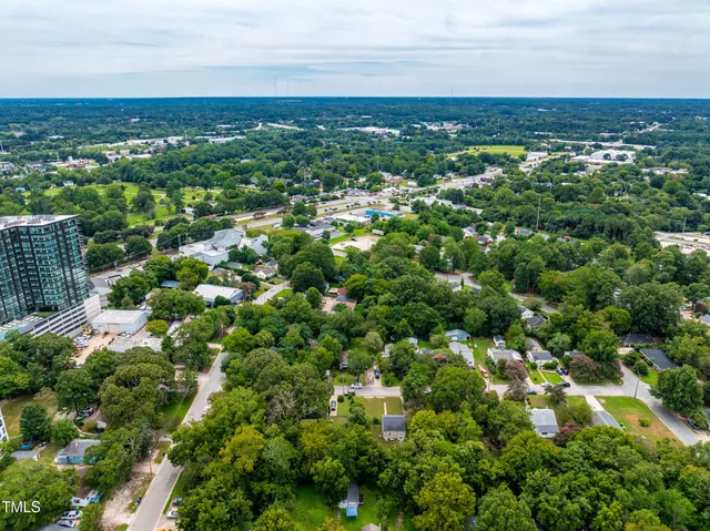 an aerial view of a house with a yard and lake view