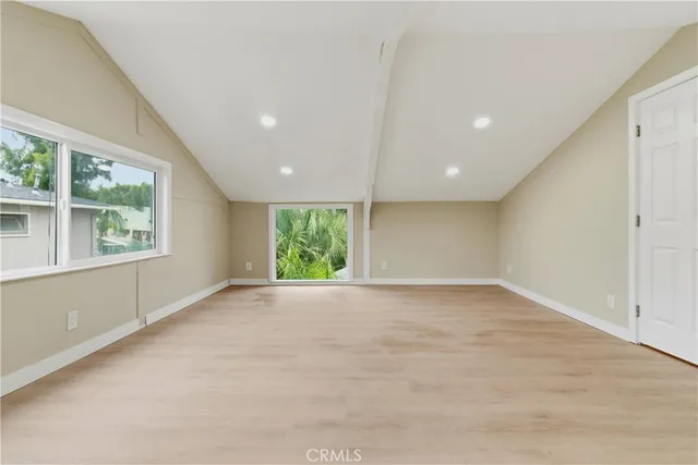 an empty room with an entryway and closet area