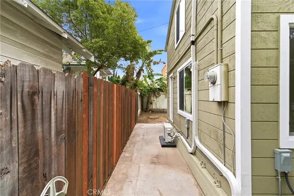 a view of a balcony with wooden floor and fence