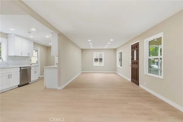 an empty room with a kitchen and a sink