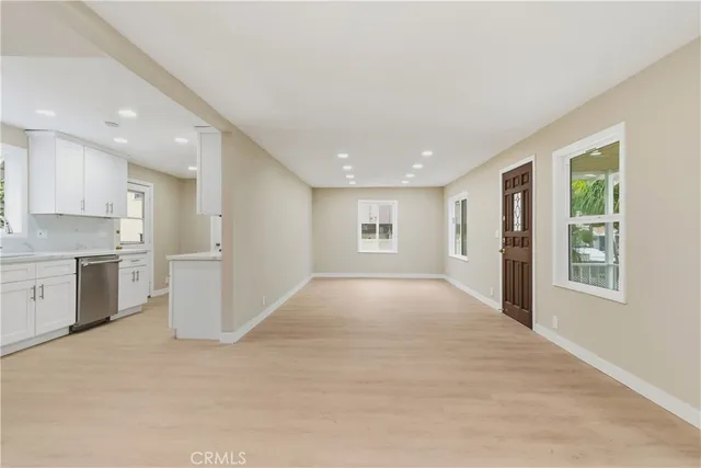 an empty room with a kitchen and a sink