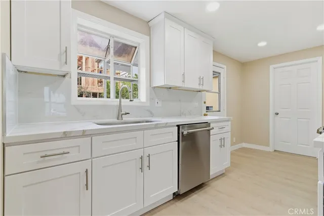 a kitchen with white cabinets and white appliances