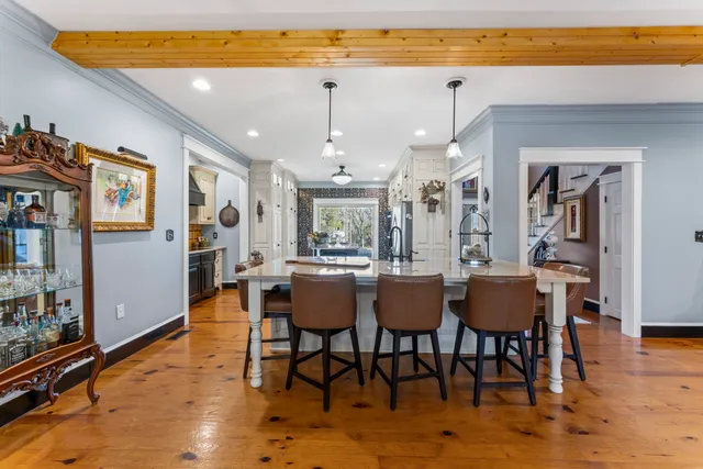 a dining room with furniture and wooden floor