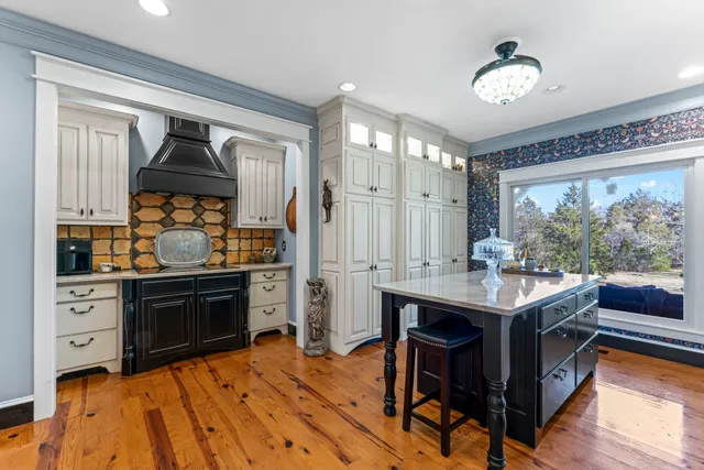 a living room with furniture a floor to ceiling window and a flat screen tv