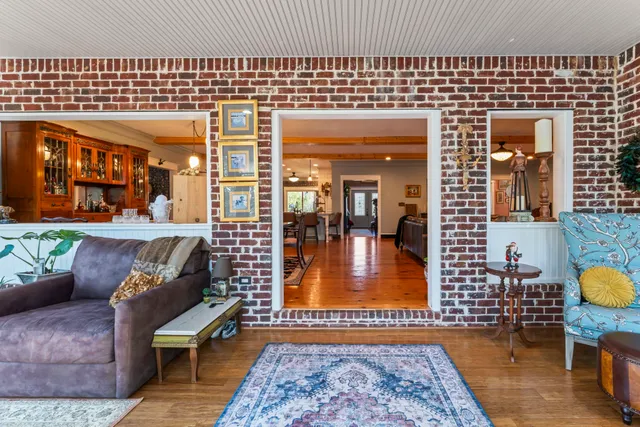 a room with furniture pool table and chandelier