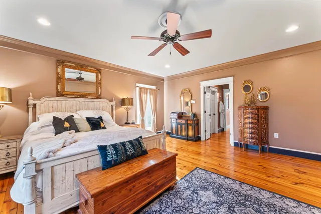 a bedroom with bed and a chandelier
