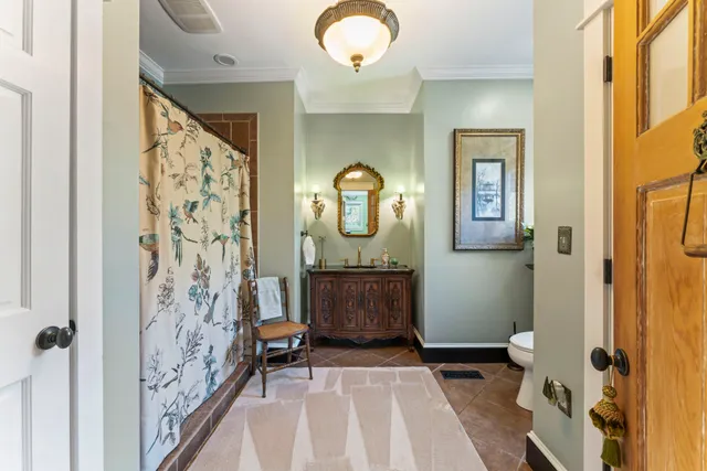a front view of a residential apartment building with a yard table and chairs