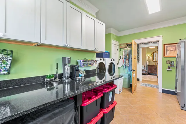 a view of a house with backyard and a tree