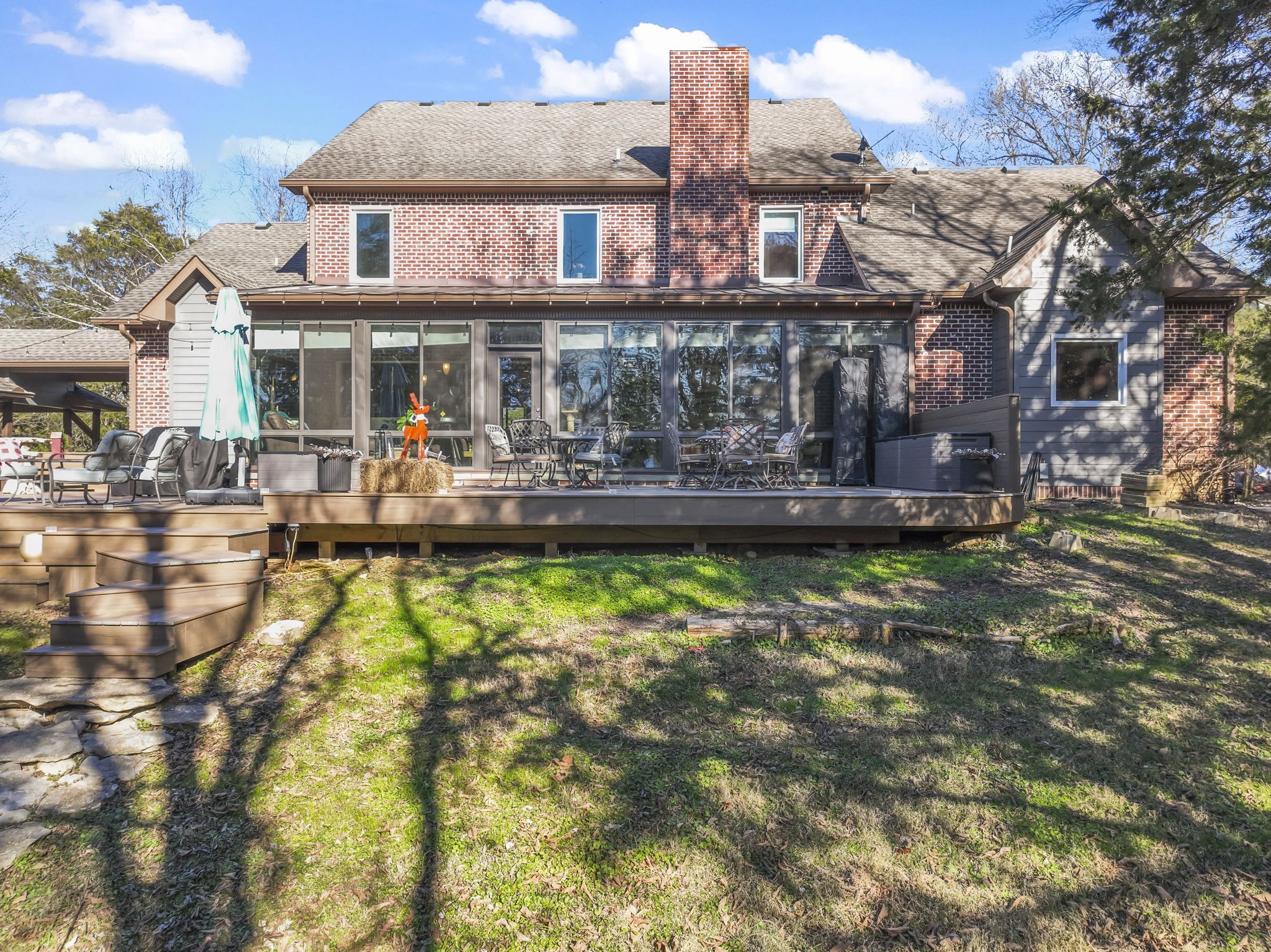 4701 Browns Mill Road Lascassas, TN 37085 - Photo 63 of 89 a front view of a residential apartment building with a yard table and chairs