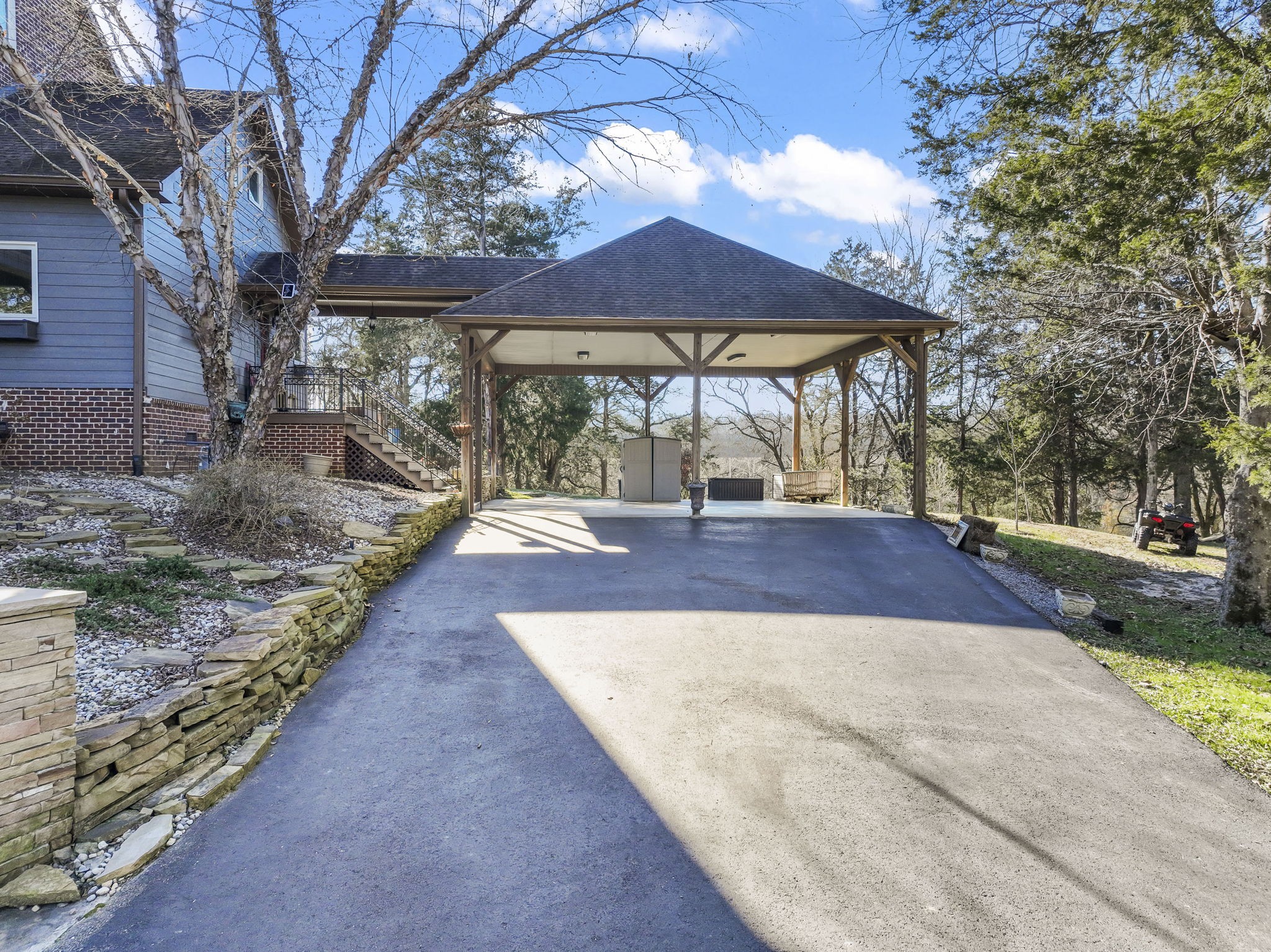 4701 Browns Mill Road Lascassas, TN 37085 - Photo 8 of 89 a view of a backyard with table and chairs under an umbrella