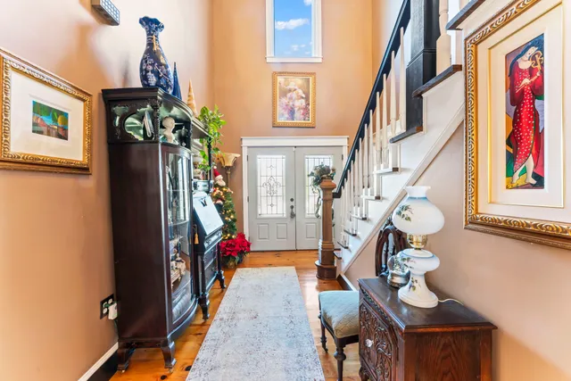 a living room with fireplace furniture and a wooden floor