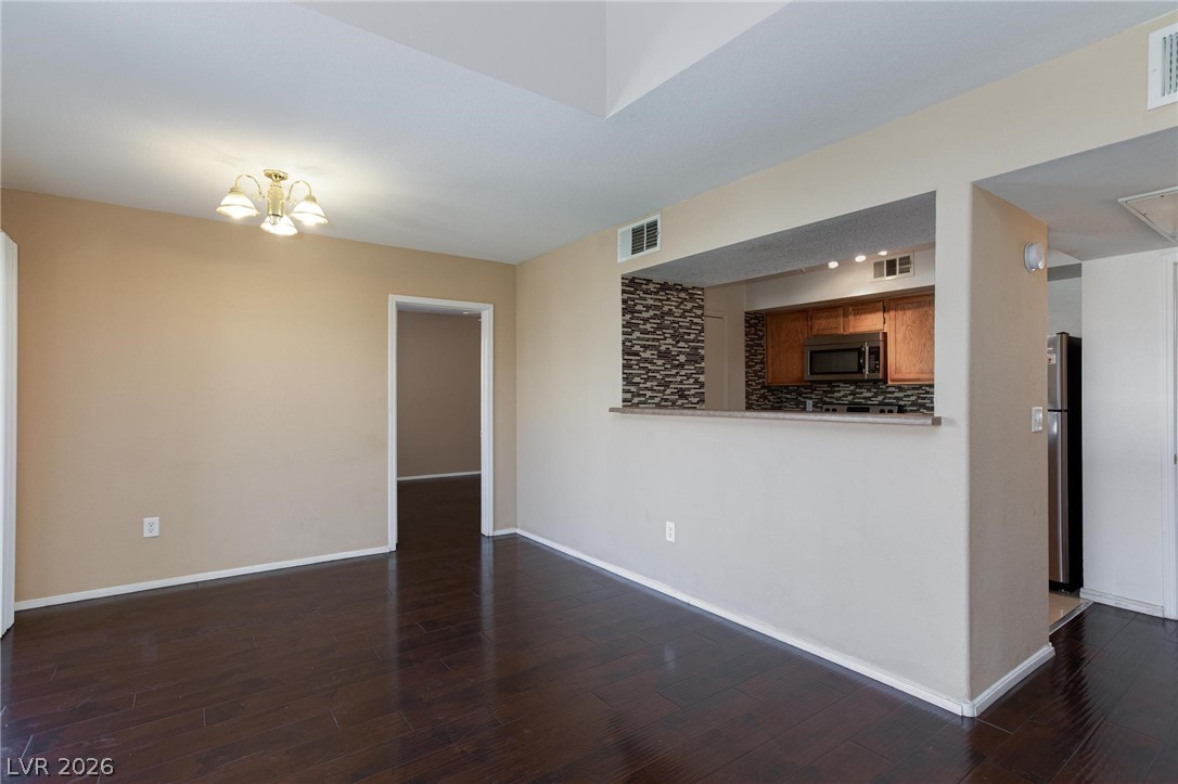 6650 West Warm Springs Road, Unit 2027 Las Vegas, NV 89118 - Photo 9 of 29 This living space features rich hardwood flooring and a convenient pass-through window to the kitchen.