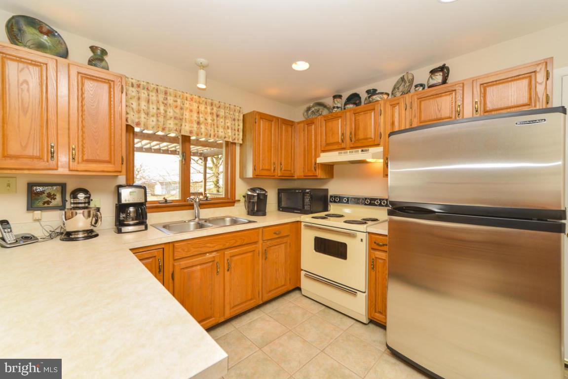 320 East Lexington Road Lititz, PA 17543 - Photo 7 of 33 a kitchen with a refrigerator a sink and cabinets