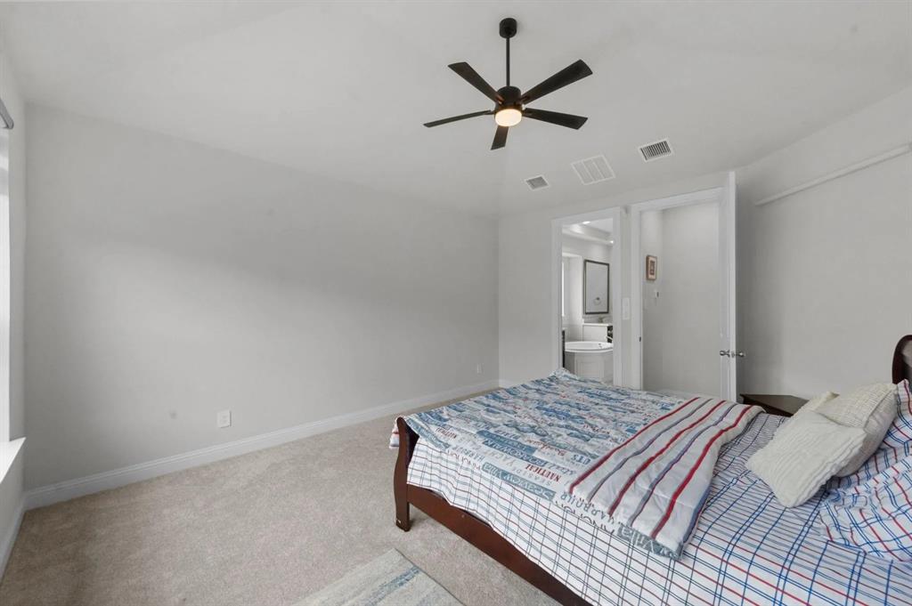 10969 Coastal Violet Road Frisco, TX 75035 - Photo 6 of 30 Bedroom featuring carpet floors, a ceiling fan, and connected bathroom