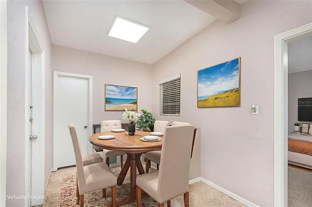 a dining room with furniture and window