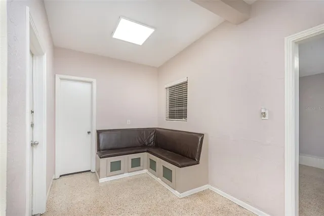a kitchen with a refrigerator and window