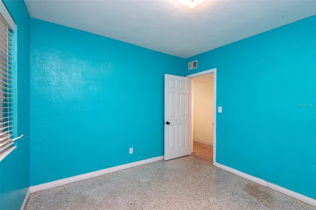 a bedroom with bed and window