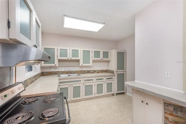 a kitchen with a stove and a refrigerator