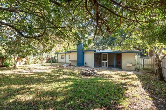a house is sitting in middle of forest