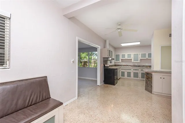 a kitchen with stainless steel appliances kitchen island a refrigerator sink and stove