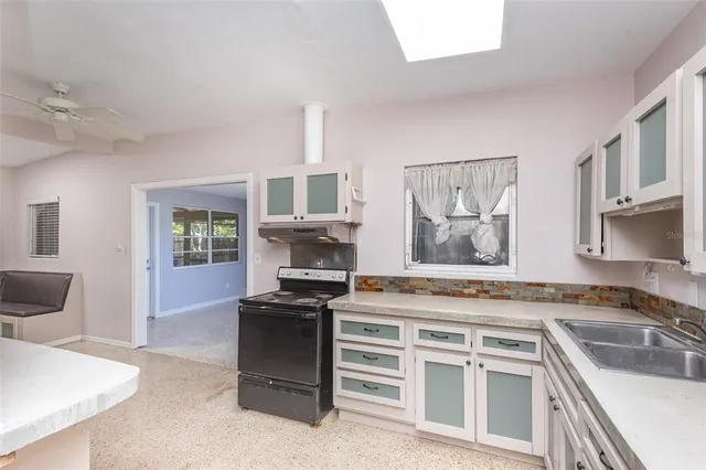 a kitchen with cabinets appliances and a sink
