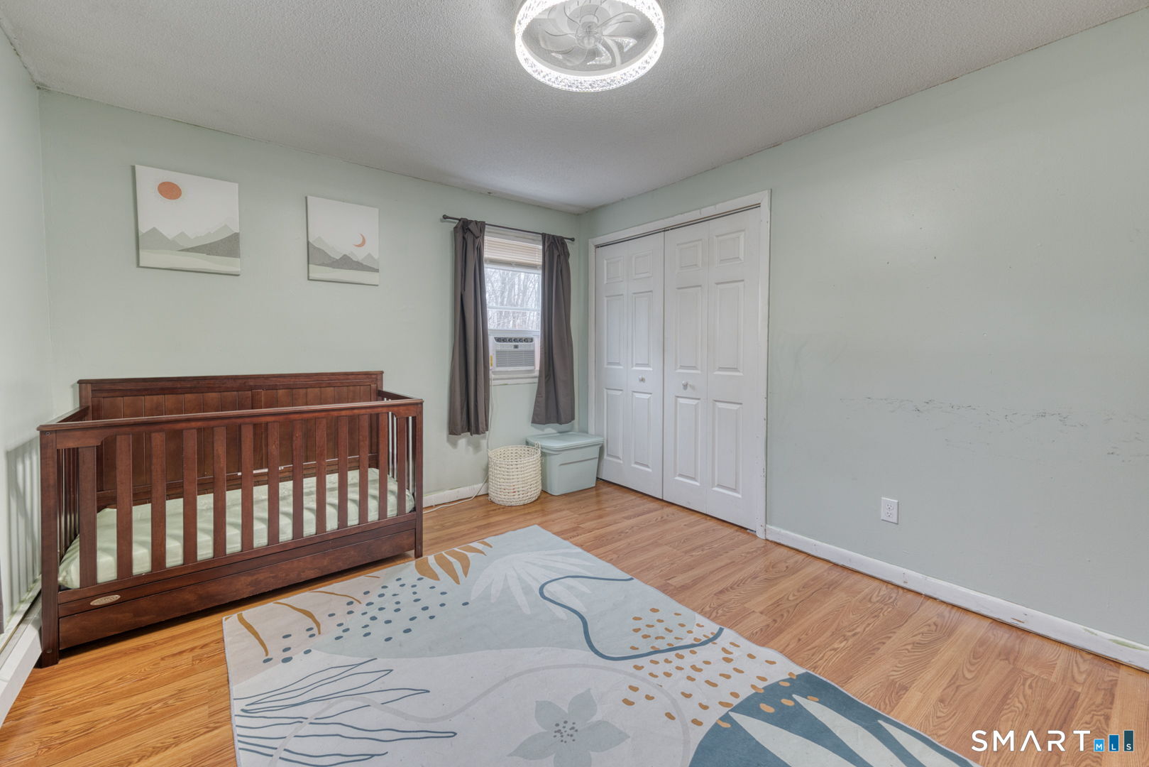 160 Windbrook Drive Windsor, CT 06095 - Photo 17 of 35 a bedroom with a bed and wooden floor