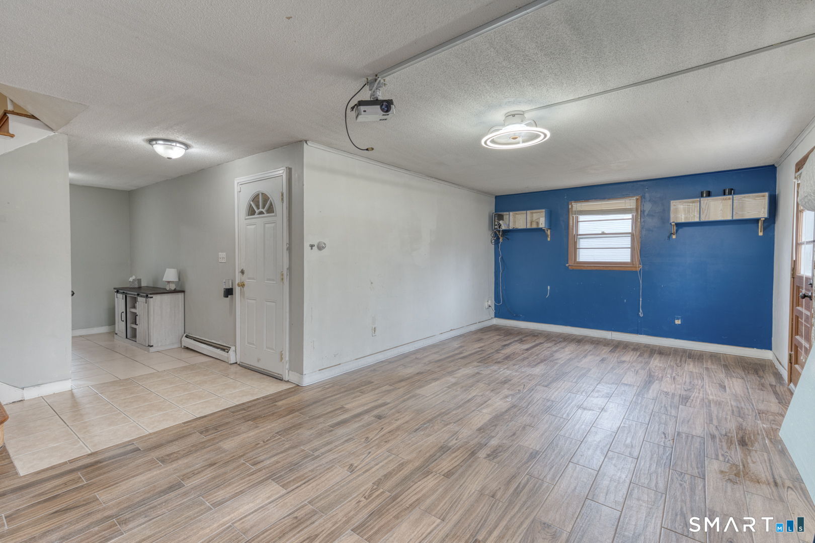 160 Windbrook Drive Windsor, CT 06095 - Photo 24 of 35 a view of an empty room with wooden floor and a window