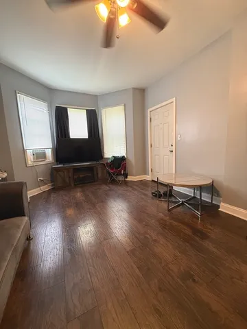 a view of a room with wooden floor and furniture