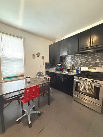 a kitchen with a sink cabinets and window