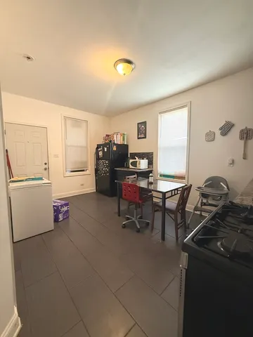 a kitchen with granite countertop a sink cabinets and appliances